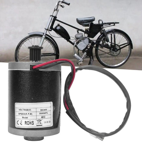 Beefy 24V 100W DC Brushed Motor with aluminum housing and metal belt pulley in front of an electric bike