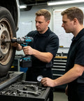 Heavy Duty 1000Nm Electric Brushless Shock Torque Wrench for Cars used by technicians on a vehicle tire in a garage.