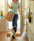 Sixteen Pack Silicone Door Stopper With Suction Cup Silent Door Stop Easy To Install in use, woman entering with dog
