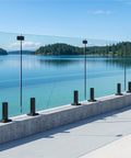 Top Shelf Frameless Glass Railing Kit Featuring Six Panels Of Crystal Clear Laminated Tempered Glass And Rock Solid Marine Grade Stainless Steel Mounting Hardware For Your Dream Outdoor Deck Project, installed on a modern deck overlooking a serene lake.