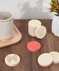 Unfinished Wooden Circles Craft Blanks, Smooth Two Inch Plywood Discs For Diy Painting And Woodburning arranged on a wooden table.