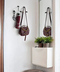 Entrance decor with Compact Brass Robe Hook For Bathroom With Glue, holding keys and purse, modern interior design.