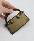 Close-up of a retro rectangle pull handle in antique bronze zinc alloy with hidden screws design, ideal for furniture like cabinets and drawers.