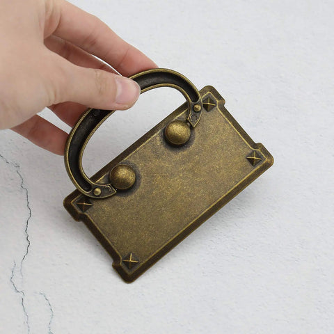 Close-up of a retro rectangle pull handle in antique bronze zinc alloy with hidden screws design, ideal for furniture like cabinets and drawers.
