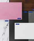 Samples of various desk finishes including pink, deep brown, black, espresso gray, white, and white marble textures.