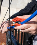 Person using Round Cable Stripper For AWG 12 To Four Zero Pro Grade Beefy Adjustable Jacket Stripping Tool on blue cable