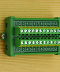 Durable Screw Mount Terminal Block Distribution Module, 12 Positions, 24A Per Position, 400V Rating, mounted on wood panel