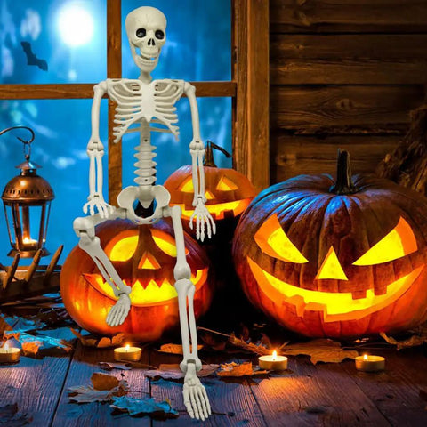 36 Inch Full Body Skeleton Prop With Movable Joints Realistic Plastic Bones next to jack-o-lanterns in Halloween display