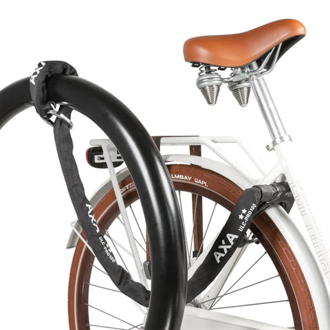 100 cm Plug-In Chain Bike Lock With 5.5 MM Hardened Steel Links securing a bicycle to a black pole for street parking.