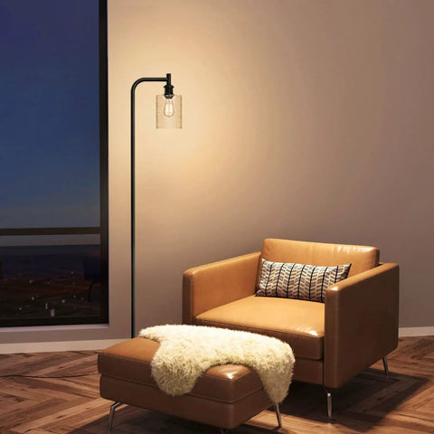 Modern Black Floor Lamp With Seeded Glass Shade Dope Bright LED Bulbs Industrial Tall Pole Standing Lamp For Living Room Bedroom Or Office Sleek Yet Sturdy Lighting That Fits Any Decor next to leather chair in living room