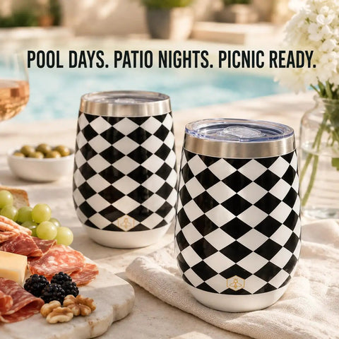 Premium Double Wall Insulated Stemless Wine Tumblers With Slider Lids 12 Oz Set displayed with snacks by a pool, black and white checkered design.