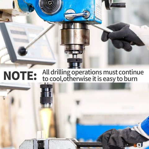 Blue drill press in a workshop; gloved operator adjusts the spindle over a clamped metal workpiece.