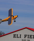 Carbon Cub 15cc ARF Ready To Fly RC Plane With Laser Cut All Wood Construction soaring above a hangar