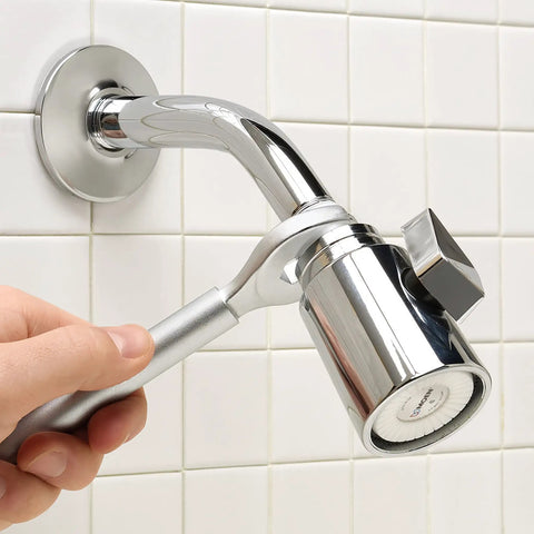 Hand using One Stop 2-In-1 Wrench For Angle Stops And Compression Couplings to adjust plumbing valve against tiled wall