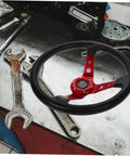 Universal 14 Inch PU Racing Steering Wheel with Horn Button Red Drift Wheel on a workbench, comfortable grip visible