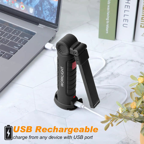 Six Pack Rechargeable LED Work Lights With Magnetic Base And 360 Degree Spin charging via USB next to a laptop
