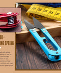 Blue tool with integrated spring, highlighting effective spring mechanism, related to 240 Piece Compression Springs Kit.