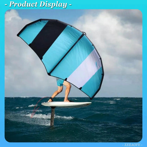 Rider using Go Anywhere Packable Inflatable Wing with Hydrofoil for wing foiling on ocean waves, blue and black wing visible