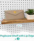Wooden pegboard shelf with lip holding an envelope and small plant on a 14x4 inch pegboard, shown installed.
