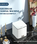 Portable Ultrasonic Washing Machine Mini Underwear Washer Compact Laundry Device on marble surface