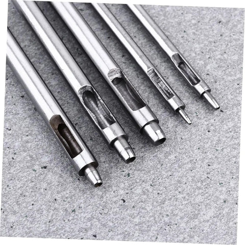 Close-up of metal Leather Round Punch Tool Belt Hole Punch For Falconry Hobbies Crafts And DIY Projects on grey surface