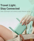 Person placing Pocket WiFi 7 Travel Router With Dual Band 2.4G And 5G Speeds Dual 2.5G Ethernet Ports USB 3.0 into a bag.