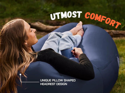 Person lounging on Inflatable Couch Air Lounger Chair No Pump Needed For Camping And Beach Trips with unique pillow headrest design.
