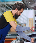 Level 5 Cut Resistant Arm Sleeves With Thumb Hole, Tough As Nails HPPE Forearm Guards For Kitchen And Workshop, Real Deal Slash Shield For Sensitive Skin, 1 Pair Blue Small worn by a man while working on a car.