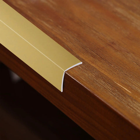 Top Tier Matte Gold L Shaped Corner Guards Peel And Stick Molding Trim For Furniture Edge Bumper on wooden tabletop.