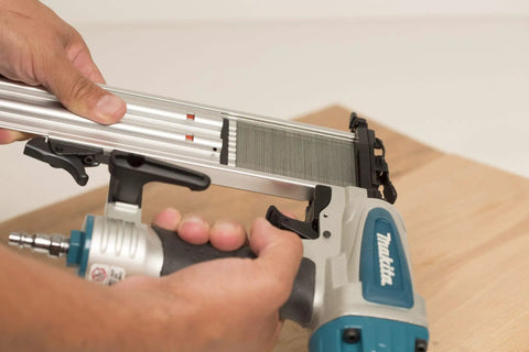 Rock Solid 18 Gauge 2 Inch Brad Nailer Kit held in hand, showing toolless jam clearing feature and depth adjustment.