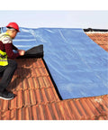 Worker applying Heavy Duty Waterproof Roofing Tape With Flexible Butyl Asphalt And Thick Aluminum Foil on tiled roof.