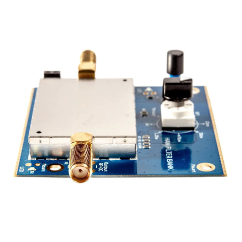Close-up of an All In One Multiband Ham Radio Filter Bank Module with Five Bandpass Filters and Passthrough on blue circuit board.