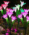 Colorful LED garden lights shaped like flowers in a garden setting, providing a vibrant display at night.