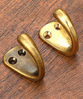 Small Solid Brass Wall Mounted Hanging Hooks Duo Pack Slick Dope Gold Finish Hella Durable Decorative Coat Rack Key Holder For Home Vibes Heavy Duty Multi Purpose Storage Solution close-up of dual brass wall hooks on wood.