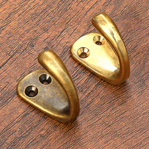 Small Solid Brass Wall Mounted Hanging Hooks Duo Pack Slick Dope Gold Finish Hella Durable Decorative Coat Rack Key Holder For Home Vibes Heavy Duty Multi Purpose Storage Solution close-up of dual brass wall hooks on wood.