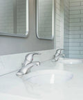 One-Handle Low Arc Bathroom Faucet Chrome Finish, 4-Inch Centerset Installation on white countertop with modern mirrors