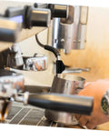 Close-up of espresso machine with steam pipe and foam pitcher using Heat Sleeve For Steam Pipe Rubber Cover For Espresso Machine Insulation Kit No Sweat Easy Replacement Safe Insulation For Pipes Durable Heat Shield Simple Install Ideal Pipe Insulation Cover For Home Use.