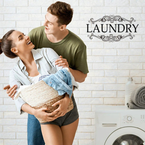 Couple carrying laundry with 'LAUNDRY' vinyl decal, part of Three Pack Large Vinyl Door Decals For Bathroom Laundry And Pantry Wall Decor Peel