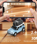Person using a smartphone to control a WLtoys 1 To 64 Scale Mini RC Car With 720P HD FPV Camera, showing live video feed.