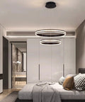 Modern Crystal Chandelier With Dimmable LED Pendant Light In Black, Acrylic Double Ring Design, in a stylish bedroom setting