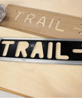 Badass Custom Wood Sign Router Template Kit Featuring Dope Arrow And Symbol Stencils for creating 'TRAIL' sign with templates.