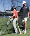 Fully Enclosed Baseball Softball Batting Cage Net With Easy Entry Door in use by player and coach on a sports field.
