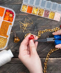 Person using pliers from 1500 Piece Silver Jump Ring Set With Lobster Clasps And Jewelry Pliers For DIY Jewelry Making Kit