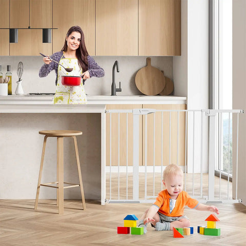 Woman cooking behind 36 Inch Extra Tall Black Baby Gate For Stairs And Doorways, 29 To 48 Inch Wide, Metal Safety Auto Close Gate with child playing