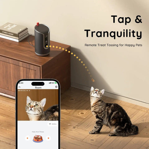 Cat interacting with 2K Pet Cam With Treat Dispenser And AI Photo Album; remote treat tossing feature shown on phone app.