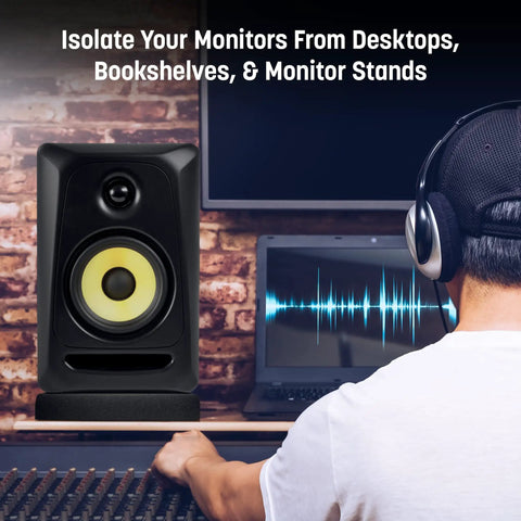 Monitor Isolation Pads For Six To Eight Inch Speakers shown on desk with acoustic foam, reducing vibrations near music producer.