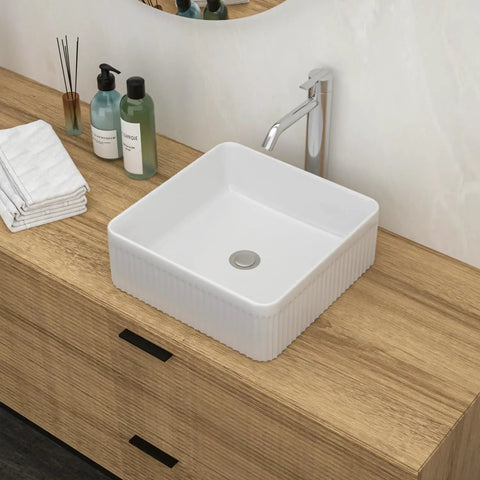 White Ceramic Square Vessel Bathroom Sink on wooden countertop with soap and towels, sleek contemporary design.