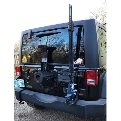 Rear view of Amazon Jack Handle Keeper mounted on Jeep tailgate; blue metal bracket for Hi-Lift and other jacks.