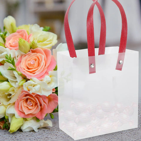 Lightweight Handheld Party Bags With Easy Handle Design 10 Pack Made of Clear PP Material Go to Gift Packaging for Birthday and Wedding Favors Party Supplies, showing red handles and a bouquet background