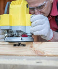 Man using a router with the Slab Flattening Router Bit Heavy Duty With One Quarter Inch Shank on a wooden board for surfacing.